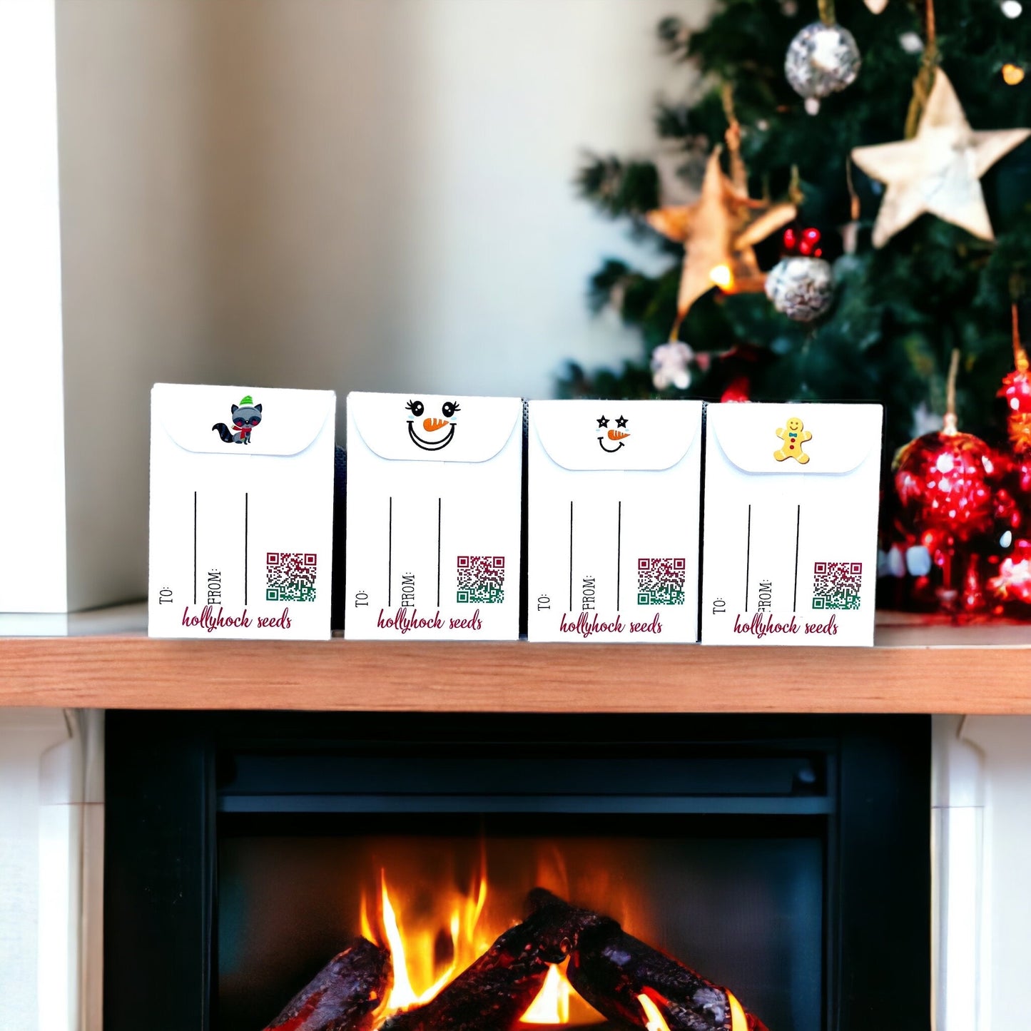 Backs of four Christmas Wish seed packets on a mantel beside a Christmas tree, showing To and From lines, QR codes, 'hollyhock seeds' and flap designs of a raccoon, snowman faces and a gingerbread man